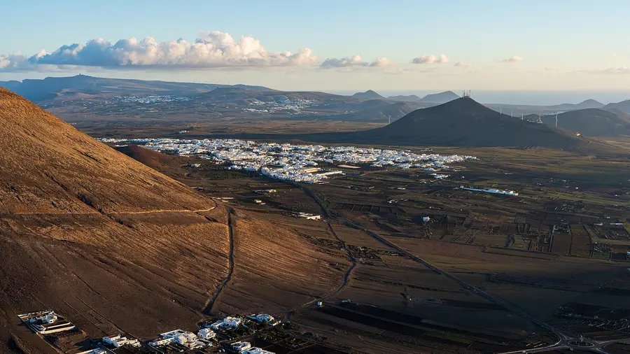 Characteristic white houses of the towns and villages on the volcanic landscape of Lanzarote.