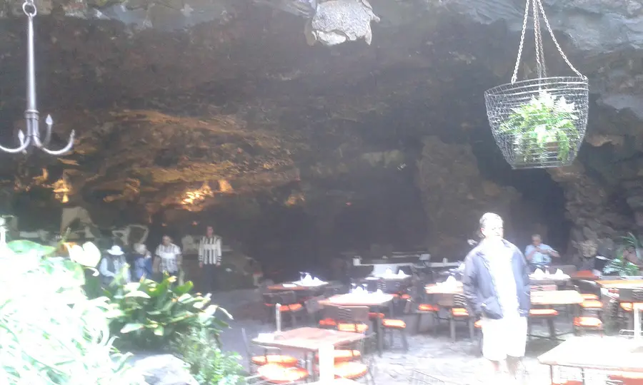 Tables and hanging plants inside the Jameos del Agua cave